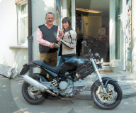 Antonio Müller übergibt Melanie Winiger ein Ducati-Motorrad