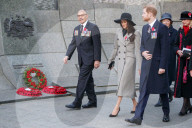 Britain's Prince Harry (3R) and his US fiancee Meghan Markle (C) walk with New Zealand's High Commissioner to the United Kingdom, Jerry Mateparae, during attend an Anzac Day dawn service at Hyde Park Corner in London on April 25, 2018. 
Anzac Day commemo
