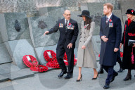 Britain's Prince Harry (2R) and his US fiancee Meghan Markle (C) walk with New Zealand's High Commissioner to the United Kingdom, Jerry Mateparae, during attend an Anzac Day dawn service at Hyde Park Corner in London on April 25, 2018. 
Anzac Day commemo