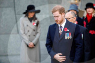 Britain's Prince Harry (C) and his US fiancee Meghan Markle (L) attend an Anzac Day dawn service at Hyde Park Corner in London on April 25, 2018. 
Anzac Day commemorates Australian and New Zealand casualties and veterans of conflicts and marks the annive