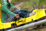 Rodelbahn Frau  zieht am Bremshebel