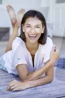 Happy woman lying on the deck