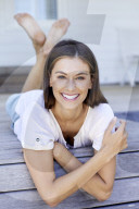 Happy woman lying on the deck