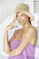 Beautiful woman playing around with straw hat