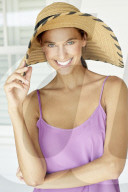 Beautiful woman playing around with straw hat