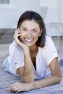 Happy woman lying on the deck