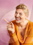 Happy Woman wearing an orange colored Top