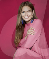 Smiling young Woman wearing a pink Outfit 