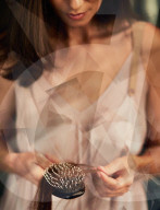 Brown-haired Woman holding a Hairbrush