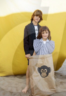 Summer Fashion: Boy and a Girl, who is standing inside an oversized Paperbag with Monkey Print