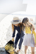 Summer Fashion: Two Girls at the Beach with a Bag of Bananas