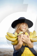 Summer Fashion: Girl with Felt Hat holding Bananas