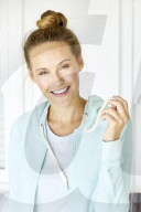 Sporty woman in mint coloured hoodie