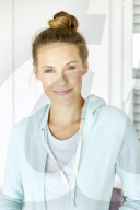 Sporty woman in mint coloured hoodie