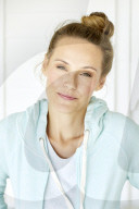 Sporty woman in mint coloured hoodie