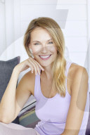 Blond woman relaxing in a lilac tank top