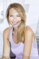 Blond woman relaxing in a lilac tank top