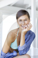 Happy woman in bikini and denim shirt 