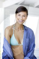 Happy woman in bikini and denim shirt 