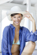 Happy woman with white straw hat 