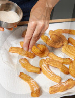 Step 8, Churros, Draining Churros and Spreading with Cinnamon and Sugar