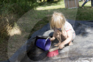 Blonde Girl playing with Handbrush, Bucket and Water