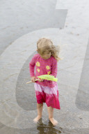 Blonde Girl at the Beach holding a Dip Net