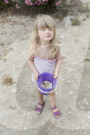 Blonde Girl holding Bucket full of Mussels