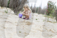 Blonde Girl collecting Mussels