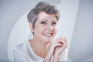 Mature Woman wearing a white Blouse