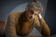 Anxious young Man wearing a brown Turtleneck Pullover