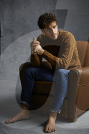 Anxious young Man wearing a brown Turtleneck Pullover