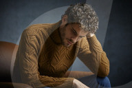 Anxious young Man wearing a brown Turtleneck Pullover