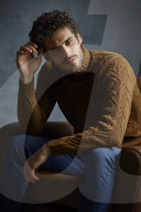Anxious young Man wearing a brown Turtleneck Pullover