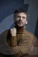 Anxious young Man wearing a brown Turtleneck Pullover