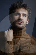 Anxious young Man wearing a brown Turtleneck Pullover