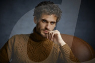Anxious young Man wearing a brown Turtleneck Pullover