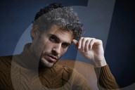 Anxious young Man wearing a brown Turtleneck Pullover