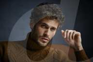 Anxious young Man wearing a brown Turtleneck Pullover