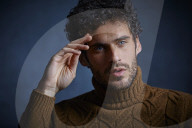 Anxious young Man wearing a brown Turtleneck Pullover