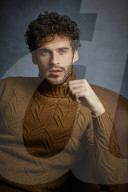 Anxious young Man wearing a brown Turtleneck Pullover
