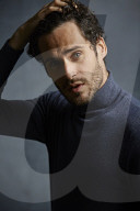 Anxious young Man wearing blue Turtleneck