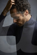 Anxious young Man wearing blue Turtleneck