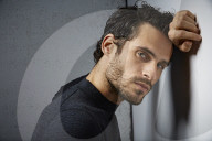 Portrait of a sorrowful Man wearing a grey Pullover