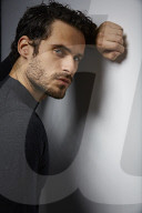 Portrait of a sorrowful Man wearing a grey Pullover