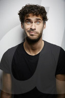 Grimacing young Man wearing a dark T-Shirt