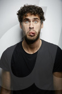 Grimacing young Man wearing a dark T-Shirt