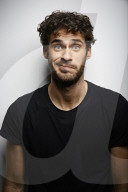 Grimacing young Man wearing a dark T-Shirt