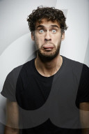 Grimacing young Man wearing a dark T-Shirt