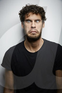 Grimacing young Man wearing a dark T-Shirt